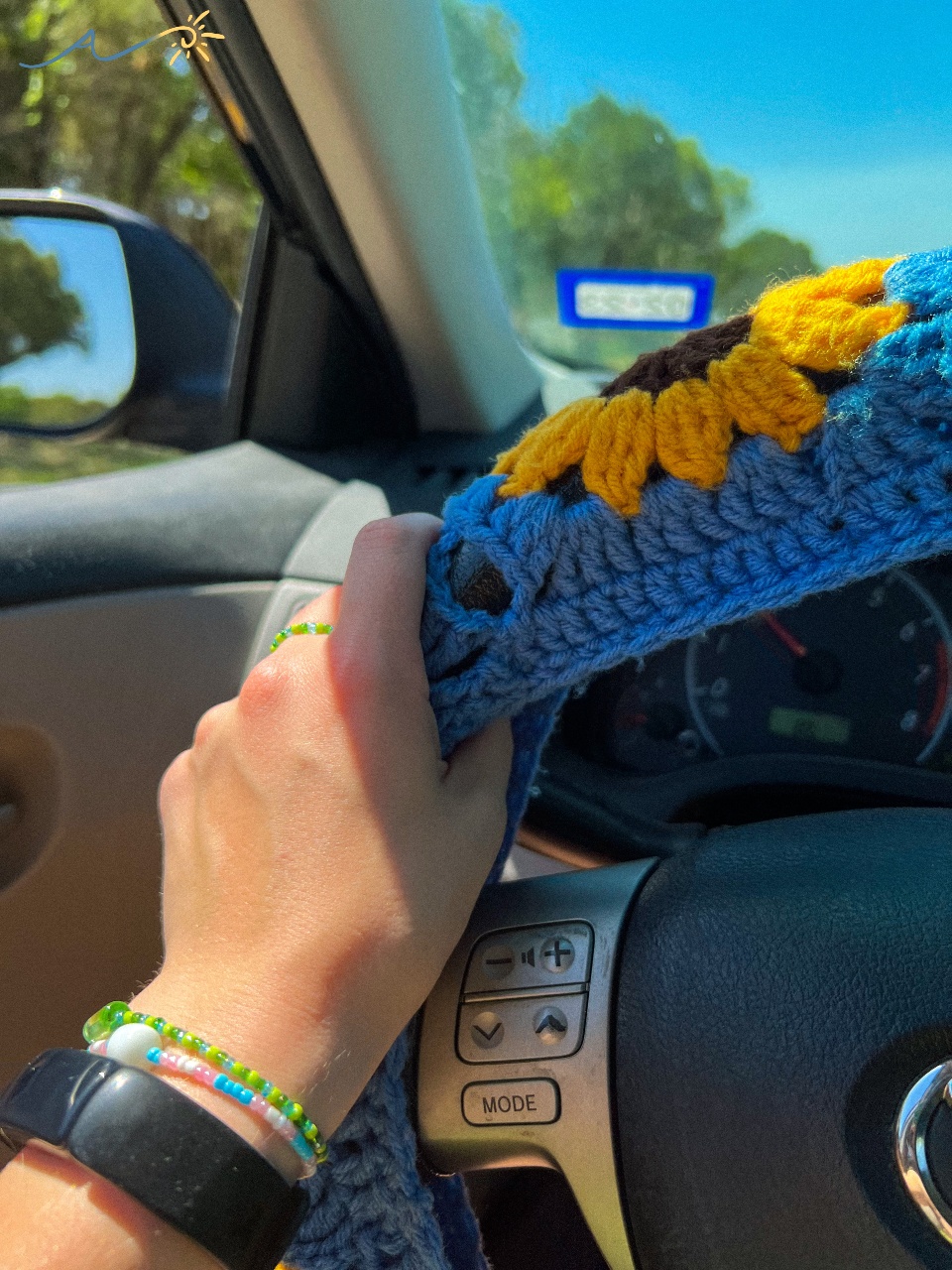 Model Jillian shows off Arts for Activism products with her crochet steering wheel.